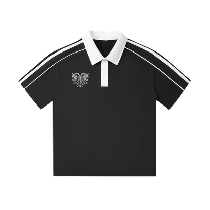 Black polo shirt with white collar, sleeve stripes, and eagle emblem, stylish men's fashion