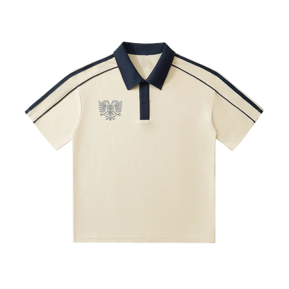 Cream polo shirt with navy collar, sleeve stripes, and eagle emblem embroidery